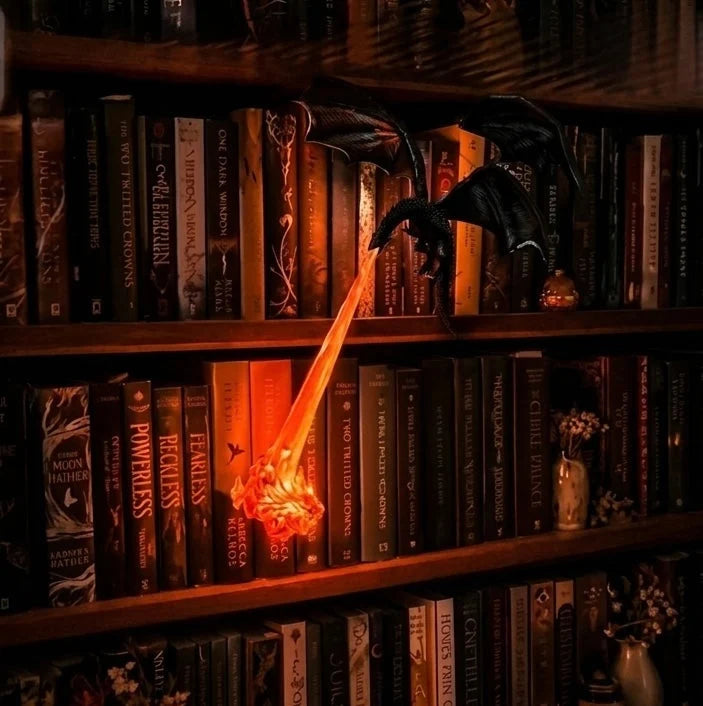 Dragon Book Lamp glowing on a bookshelf at night