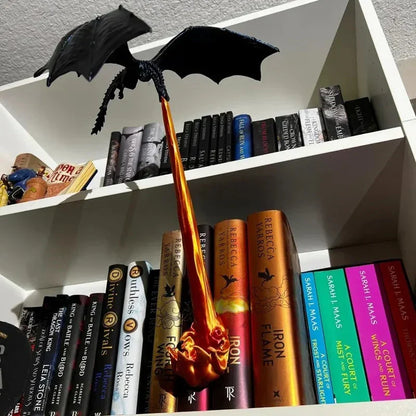 Dragon Book Lamp breathing fire between two shelves